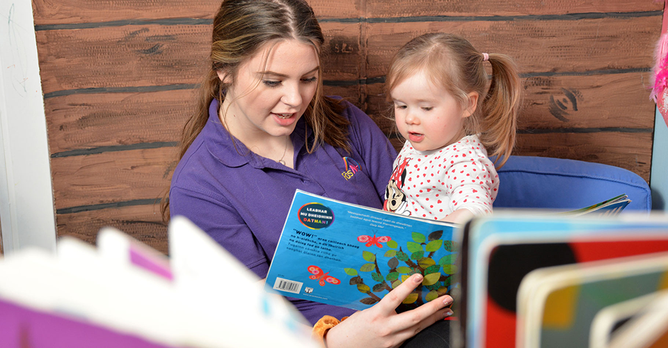 Picture of a student reading to a child